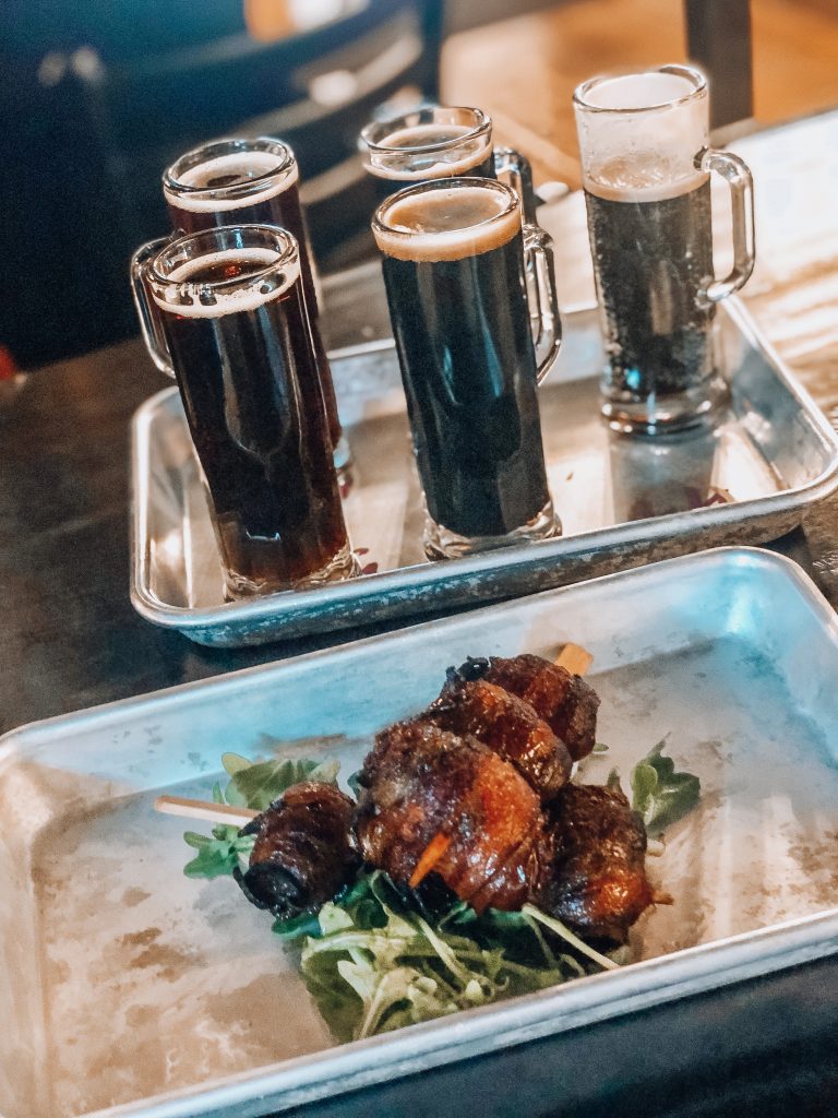 flight of beers from stein leavenworth with bacon wrapped figs in a blanket